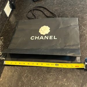 Chanel black paper shopping bag. Slightly worn.